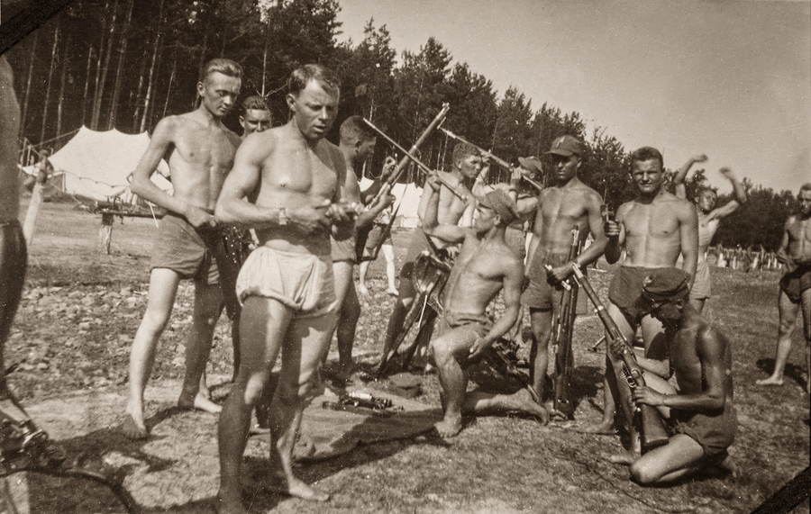 Zdjęcie 003. Żołnierze na obozie szkoleniowym z polskimi karabinkami wz. 29 (kbk wz. 29). Prawdopodobnie był to obóz Dywizyjnego Kursu Podchorążych Rezerwy w 39 Pułku Piechoty Strzelców Lwowskich w Jarosławiu w 1935 r. Jan Nycz stoi czwarty z prawej (ma na głowie furażerkę, karabin u nogi).