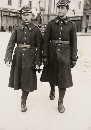 Zdjęcie 011. Starszy strzelec Tadeusz Kuziara (z lewej) z kolegą podczas służby w 5. Pułku Strzelców Podhalańskich w Przemyślu (1937–1938) na spacerze po Rynku w Przemyślu. Na drugim planie widoczny jest kościół Ojców Franciszkanów.