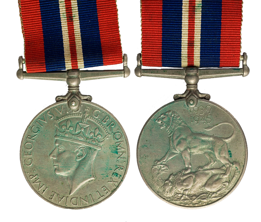 Zdjęcie 028. Awers i rewers odznaczenia The War Medal 1939–1945 (Medal za Wojnę 1939–1945) przyznanego kpt. Franciszkowi Cieplikowi. Na awersie znajduje się profil króla Jerzego VI, na rewersie widoczny jest lew – symbolizujący Koronę Brytyjską – depczący dwugłowego smoka – symbolizującego hitlerowskie Niemcy.